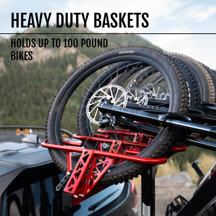 Bicycles mounted on a red heavy-duty bike rack with text about weight capacity.